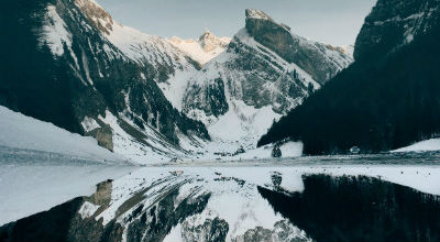 Snow capped mountain reflected in clear lake